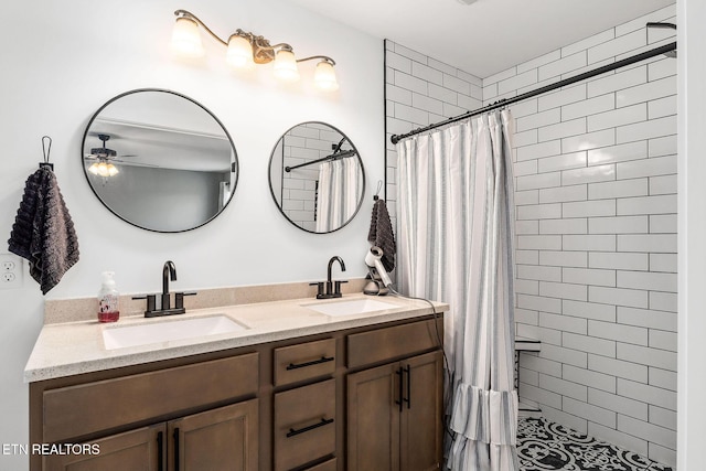 bathroom featuring ceiling fan, walk in shower, and vanity