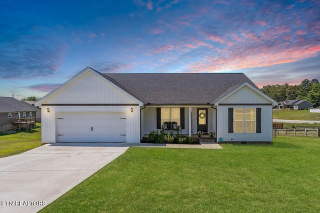 single story home with a lawn and a garage