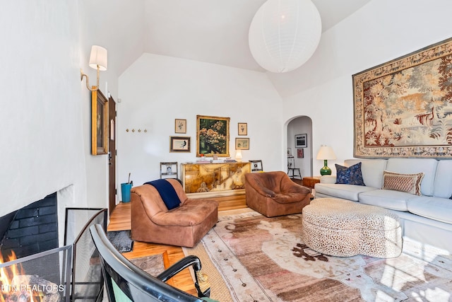 living room featuring hardwood / wood-style floors and high vaulted ceiling