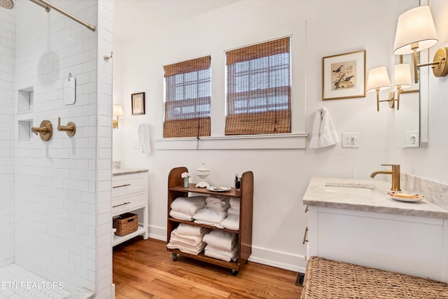 bathroom with vanity, wood-type flooring, and a shower with shower door