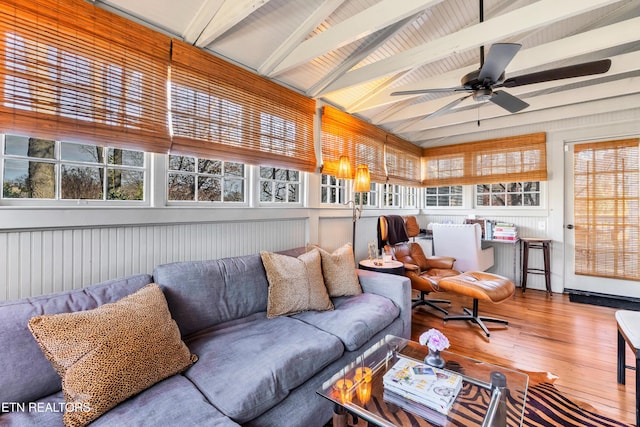 sunroom / solarium featuring vaulted ceiling with beams and ceiling fan