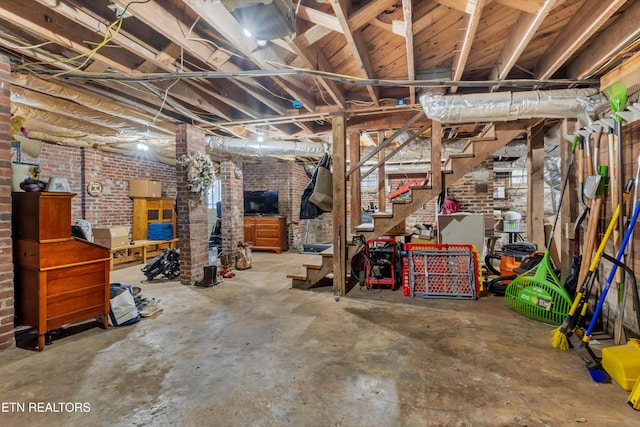 basement with brick wall