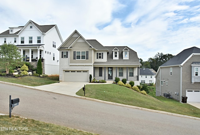 view of front of house featuring a garage, central AC unit, and a front lawn