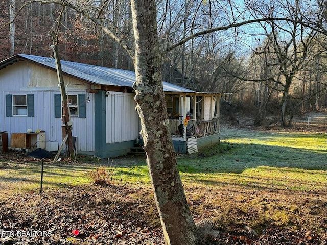 view of side of home with a yard