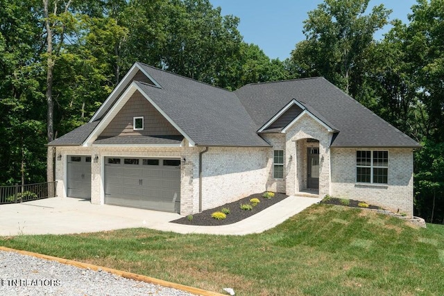 view of front of house featuring driveway, a garage, a shingled roof, a front lawn, and brick siding