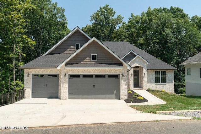 craftsman house featuring driveway, a shingled roof, an attached garage, fence, and brick siding