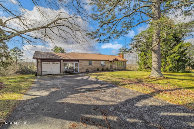 single story home with a garage and a front lawn