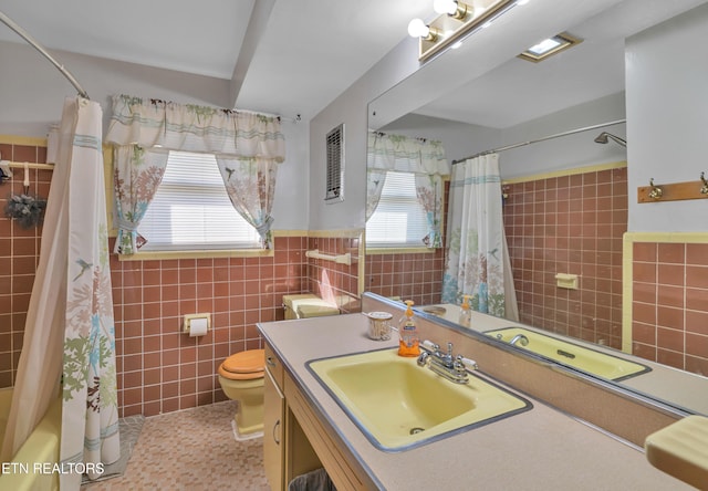 full bathroom featuring tile patterned flooring, shower / bath combo, plenty of natural light, and tile walls