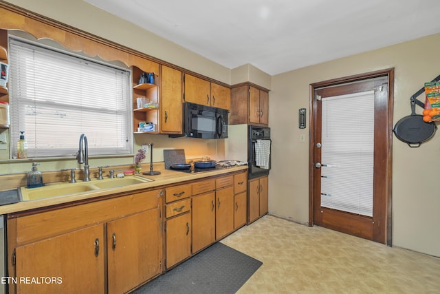 kitchen with sink and black appliances