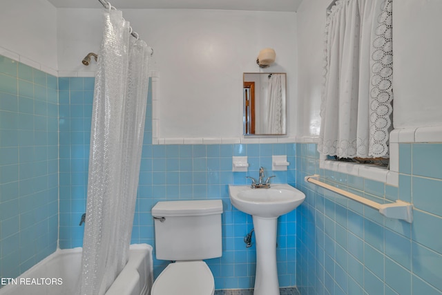 bathroom featuring shower / tub combo, tile walls, and toilet