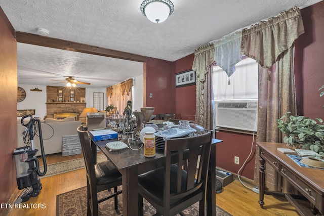 dining room with wood-type flooring, a textured ceiling, and ceiling fan