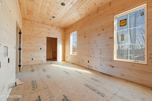 empty room featuring wooden walls