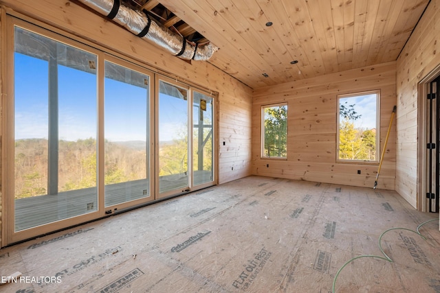 unfurnished sunroom with wooden ceiling