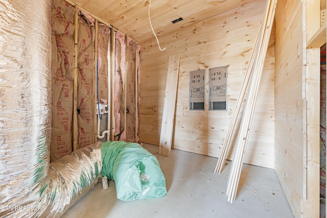 miscellaneous room with wood walls, wooden ceiling, and concrete floors