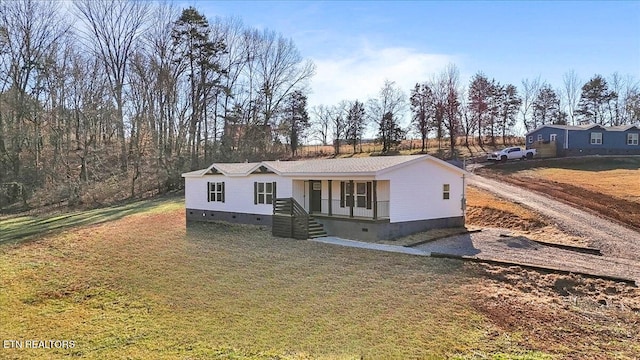 view of front of home featuring covered porch and a front yard