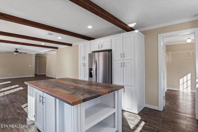 kitchen featuring stainless steel refrigerator with ice dispenser, butcher block countertops, white cabinetry, and a kitchen island