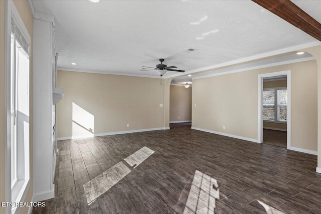 unfurnished living room featuring beamed ceiling, ceiling fan, and a textured ceiling