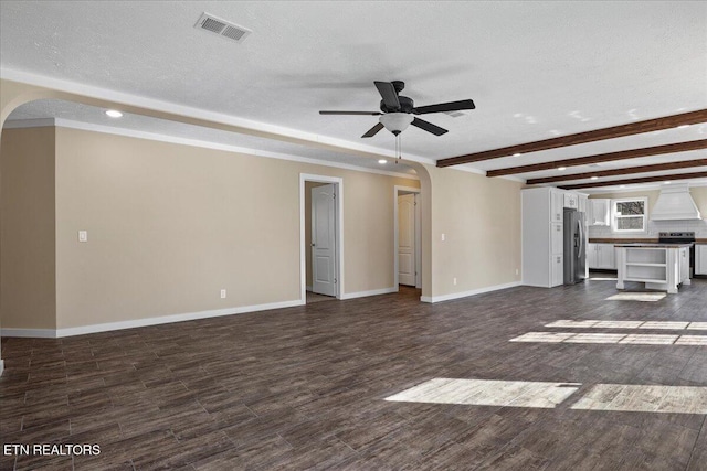 unfurnished living room featuring ceiling fan and a textured ceiling