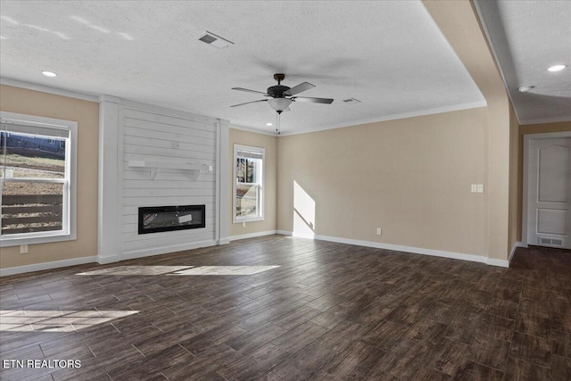 unfurnished living room with a fireplace, a textured ceiling, plenty of natural light, and ceiling fan