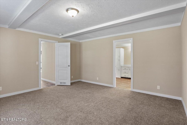 unfurnished room featuring beam ceiling, light carpet, and a textured ceiling