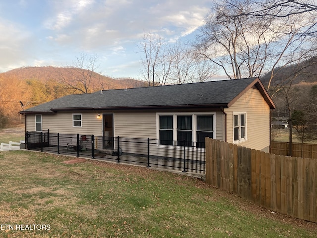 exterior space featuring a mountain view and a lawn