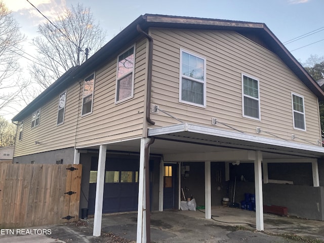 back of property with a carport