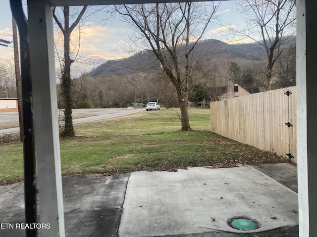 view of yard featuring a patio and a mountain view