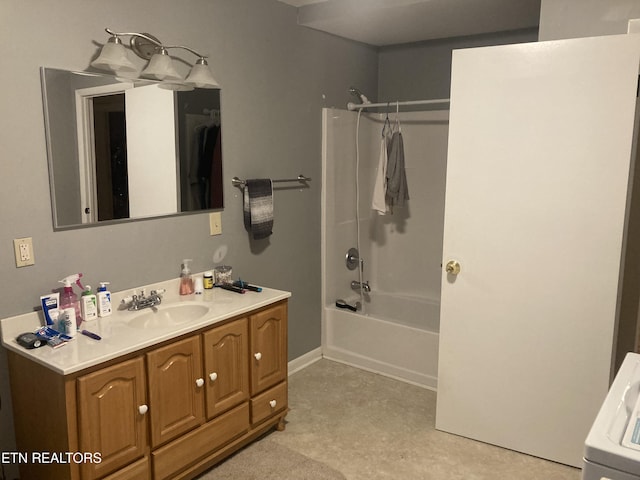 bathroom with washer / clothes dryer, shower / washtub combination, and vanity