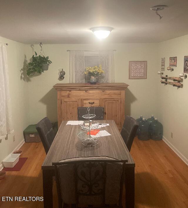 dining area with wood-type flooring