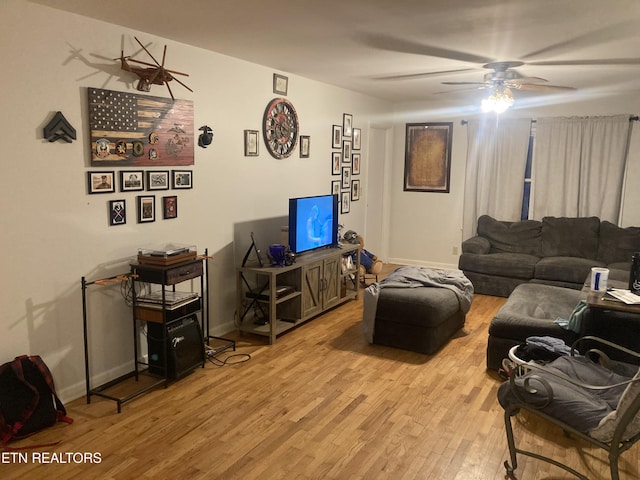 living room featuring light hardwood / wood-style floors and ceiling fan