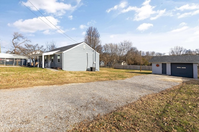 view of property exterior with a lawn, central air condition unit, a porch, an outbuilding, and a garage