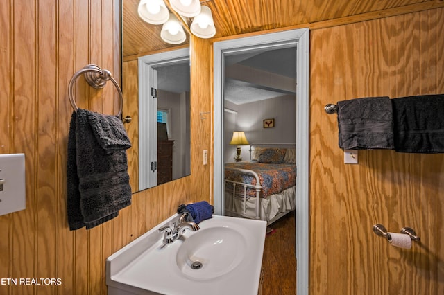 bathroom with sink and wood walls