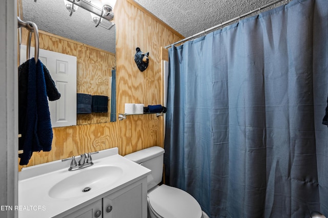 bathroom featuring vanity, toilet, curtained shower, and a textured ceiling