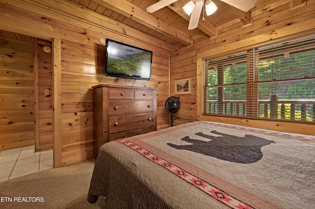 bedroom featuring beamed ceiling, tile patterned floors, wooden ceiling, and wood walls