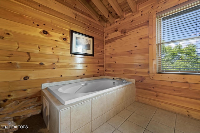 bathroom featuring wood walls, wooden ceiling, tile patterned flooring, vaulted ceiling with beams, and a tub