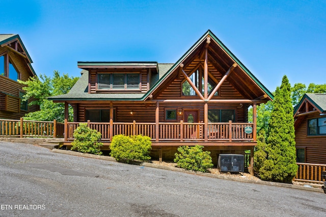 log-style house featuring a porch