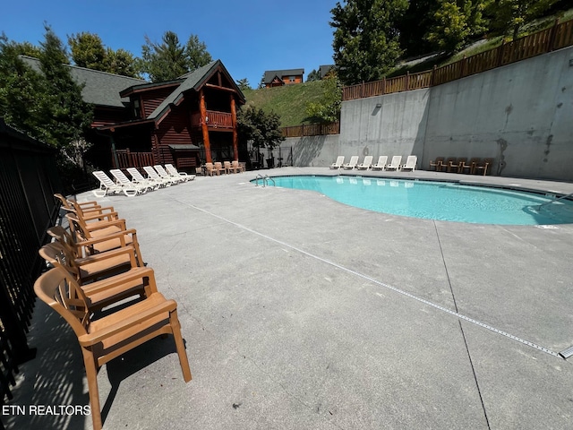 view of swimming pool with a patio