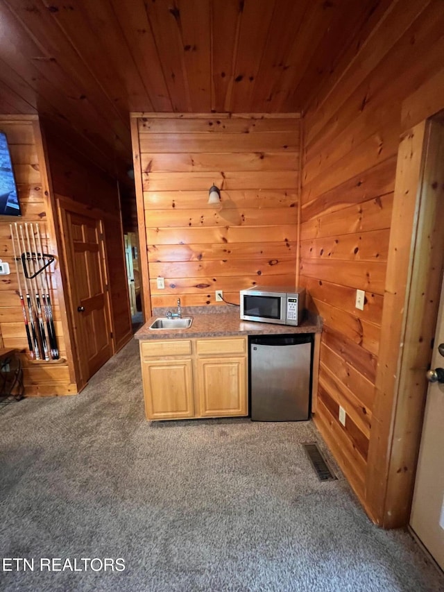 1726 Summit View Way, Pigeon Forge, TN 37862 - kitchen with appliances with stainless steel finishes, a sink, wooden ceiling, carpet flooring, and wood walls