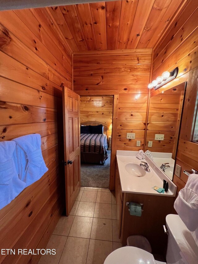1726 Summit View Way, Pigeon Forge, TN 37862 - half bathroom featuring wood walls, wood ceiling, toilet, tile patterned floors, and vanity