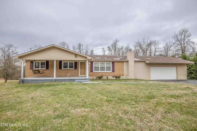 single story home featuring a front lawn, covered porch, and a garage