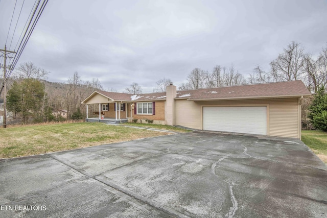 view of front of home with a front lawn, a porch, and a garage