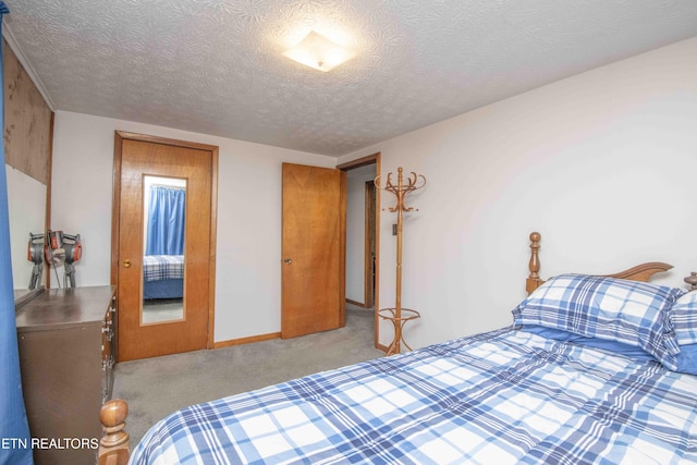 carpeted bedroom featuring a textured ceiling