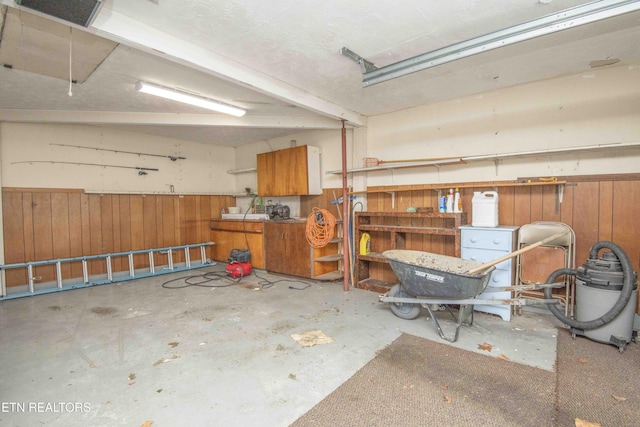 garage featuring wood walls