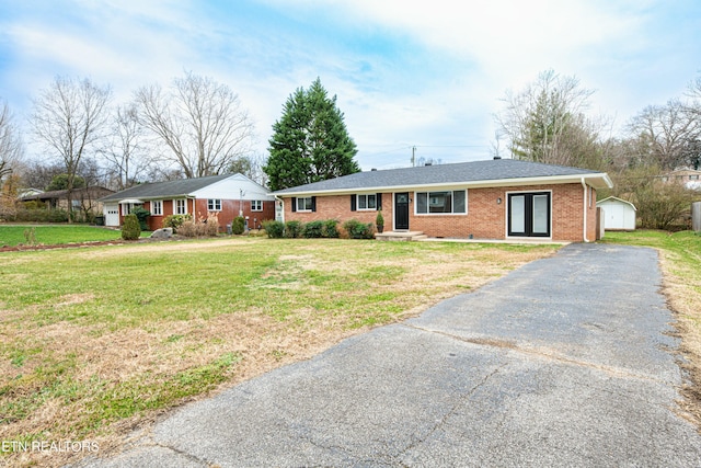 single story home featuring french doors and a front yard