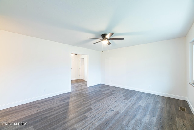 unfurnished room with dark hardwood / wood-style flooring and ceiling fan