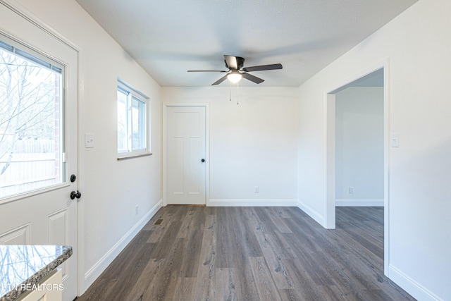 interior space featuring ceiling fan and dark hardwood / wood-style floors