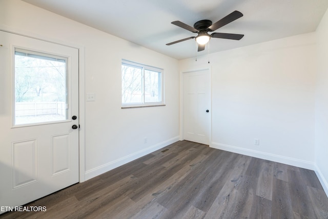 interior space featuring ceiling fan and dark hardwood / wood-style flooring