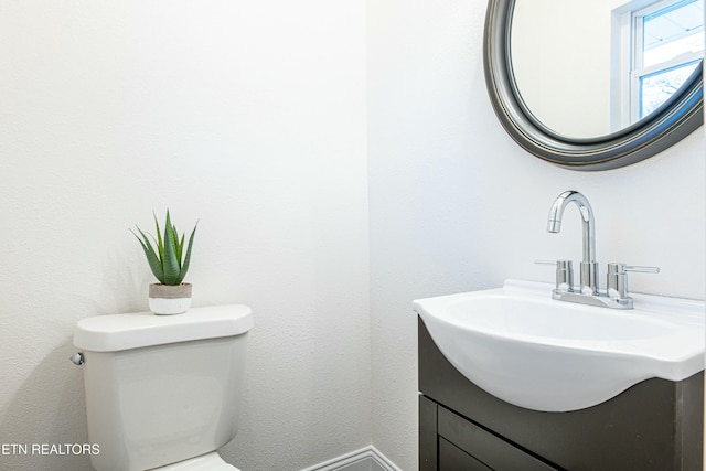 bathroom with toilet and vanity