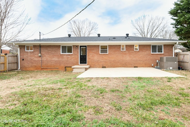 rear view of property featuring a yard, a patio, and cooling unit