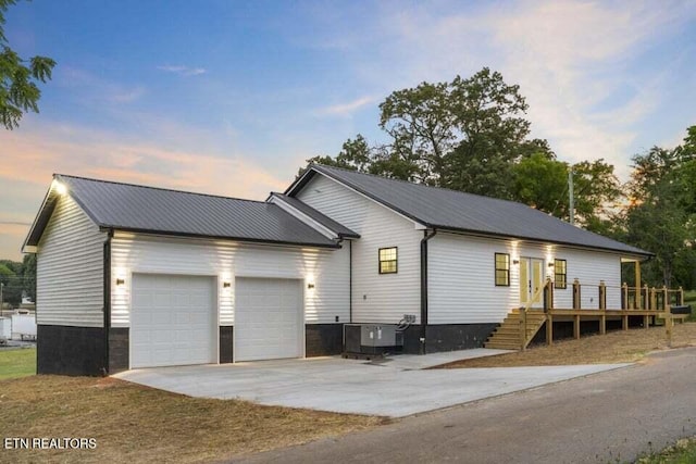 view of front of house with cooling unit and a garage